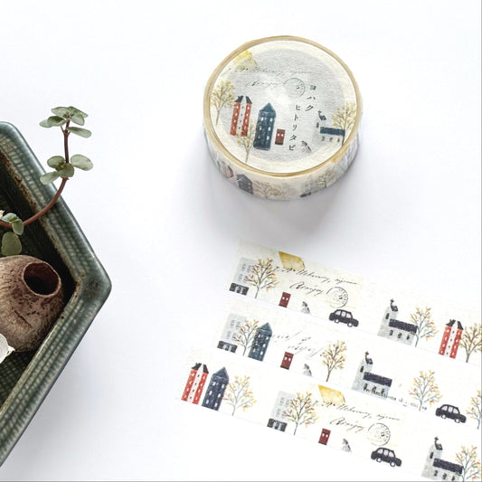 Decorative washi tape with small town design on a white surface